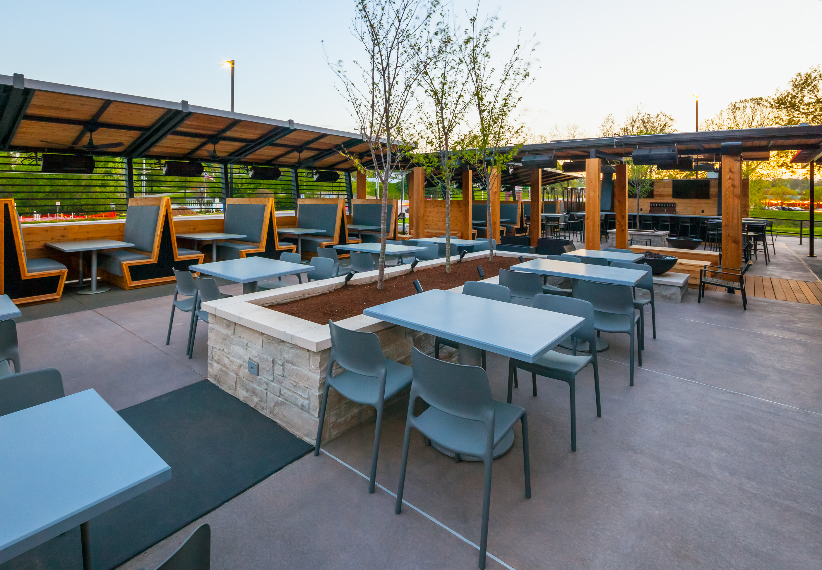 The patio features both ipe and cedar woods, and the concrete has two different colors to differentiate between seating areas. 