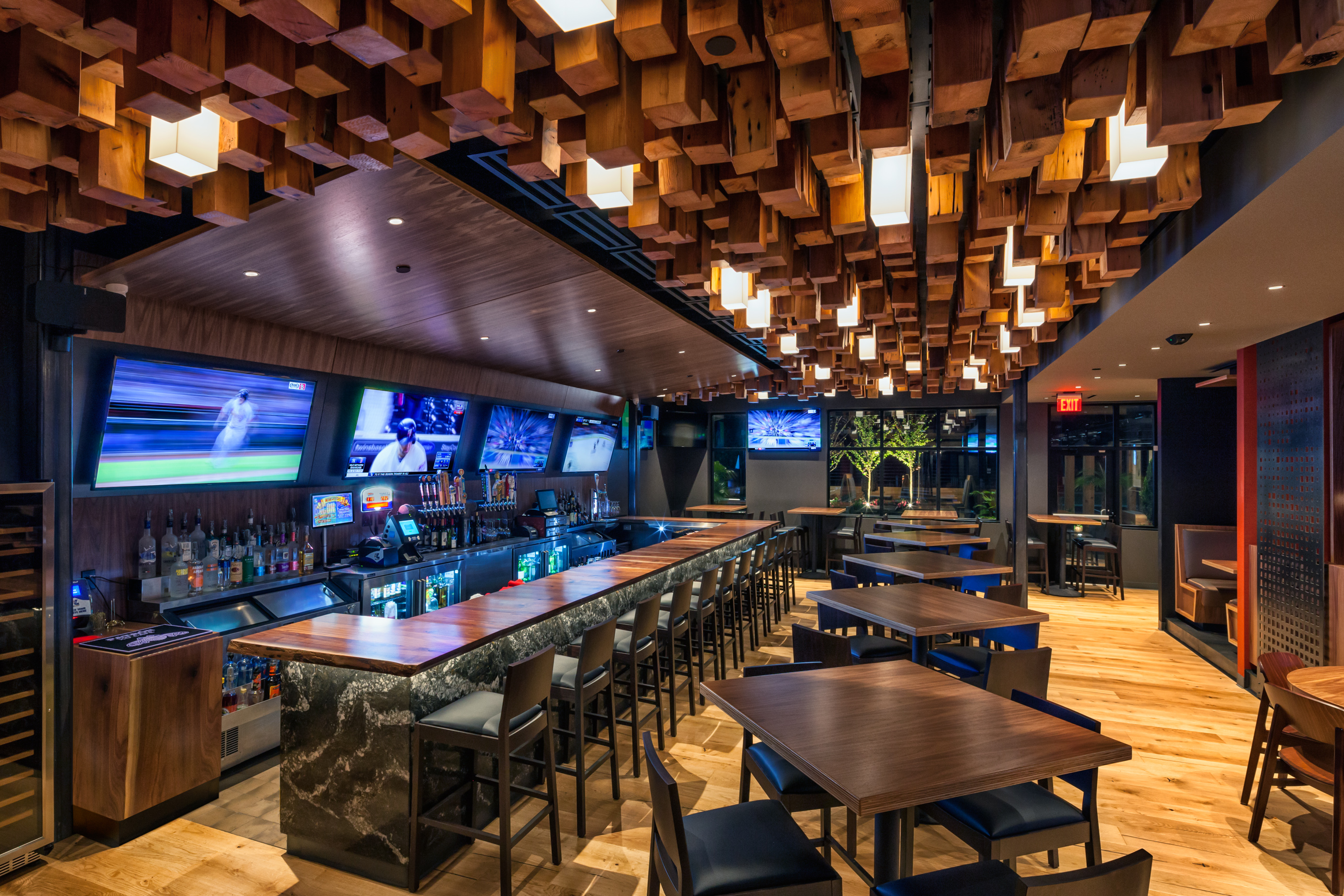 The cedar-timber ceiling with custom lights hangs over the chic bar. 